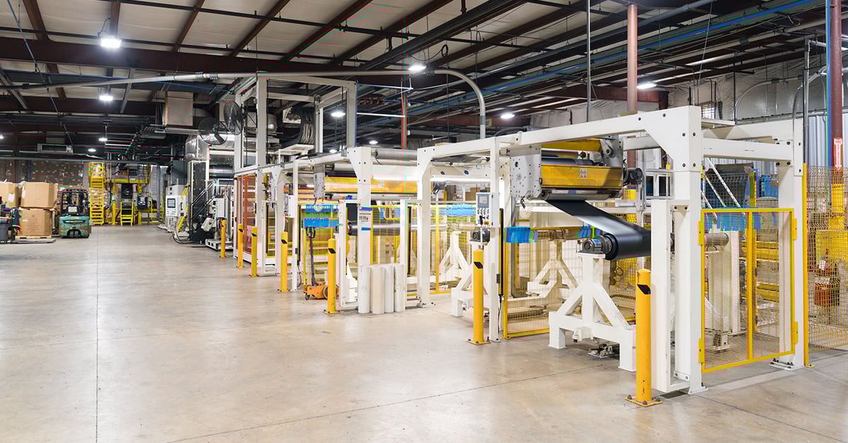 Photo of plastic extrusion line inside of manufacturing facility.